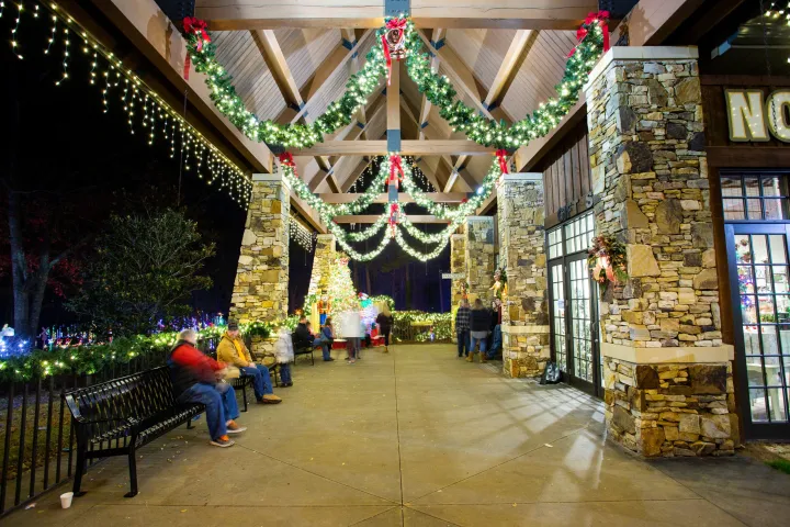 a person sitting on a bench in front of a store