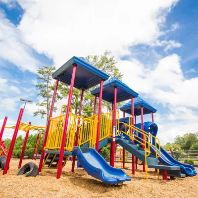 a colorful kite sitting on top of a sandy beach