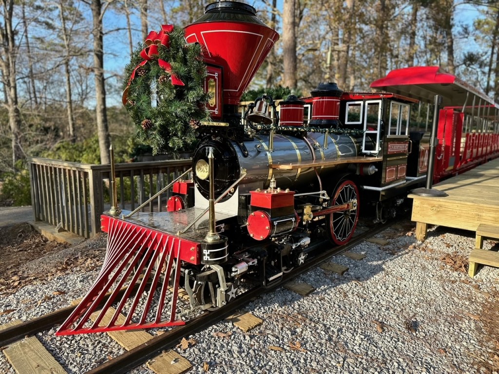 a train is parked on the side of a fence